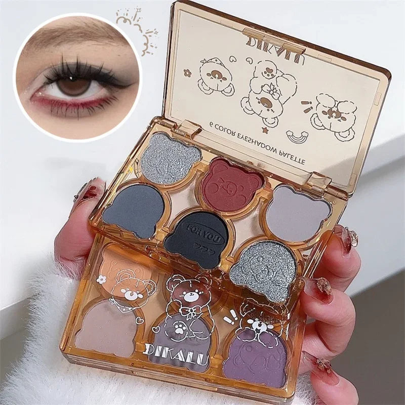Blushimmer 6-color matte eyeshadow palette with shimmering pearlescent shades in smoky gray, red, black, and wine red eye makeup