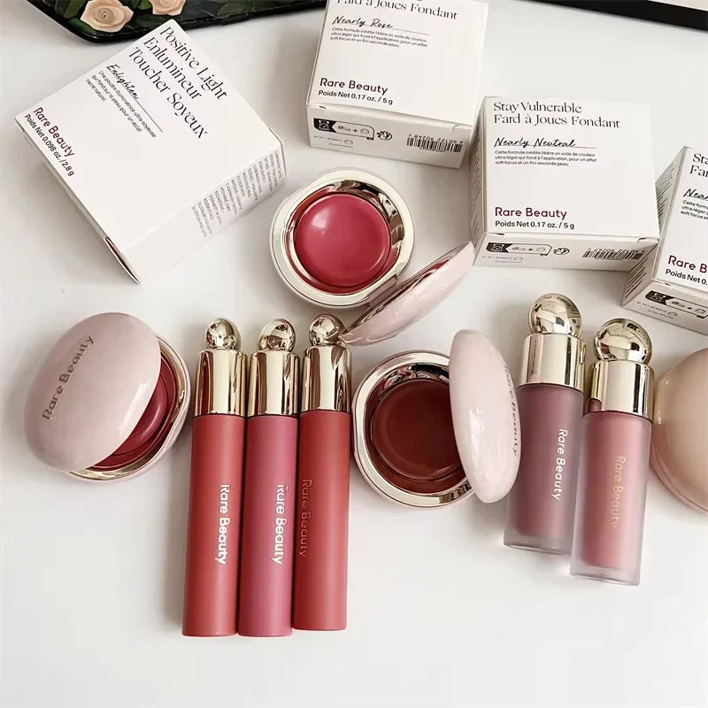 Blushimmer Rare Beauty melting cream blush with pearlescent matte finish, glitter highlighter, and nourishing lip gloss in a sleek container.
