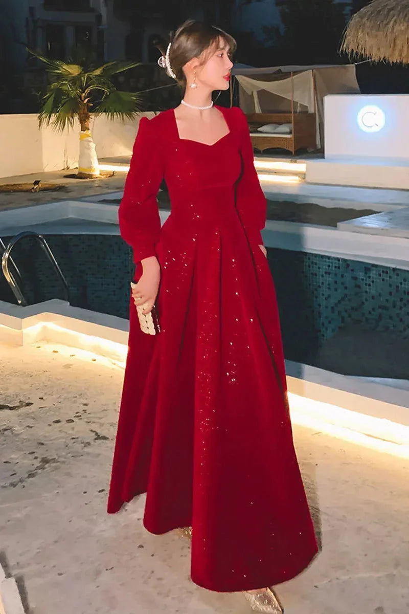 Elegant red luxury ceremony gown by Luxlife Brands, featuring flowing fabric and intricate detailing for special occasions.