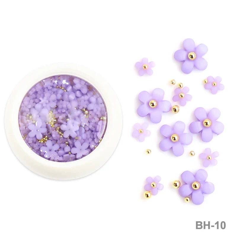White acrylic flower nail art decorations with mixed red and blue rhinestones for DIY manicure designs, by Blushimmer.