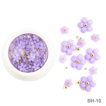 White acrylic flower nail art decorations with mixed red and blue rhinestones for DIY manicure designs, by Blushimmer.