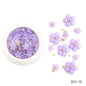 White acrylic flower nail art decorations with mixed red and blue rhinestones for DIY manicure designs, by Blushimmer.