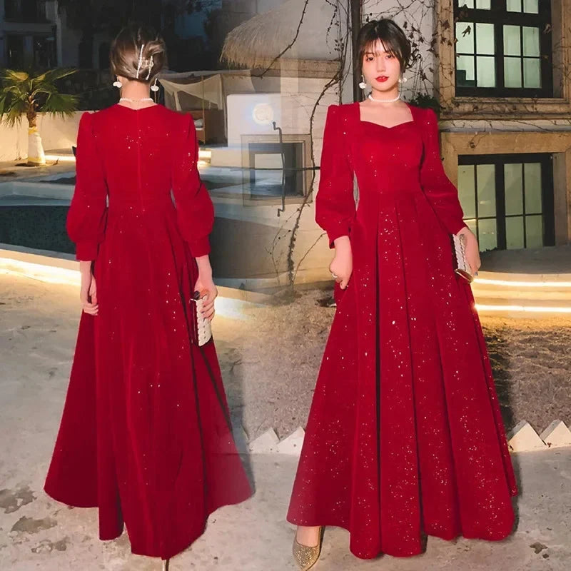 Elegant luxury red ceremony gown by Luxlife Brands, featuring intricate detailing and flowing fabric for formal occasions.