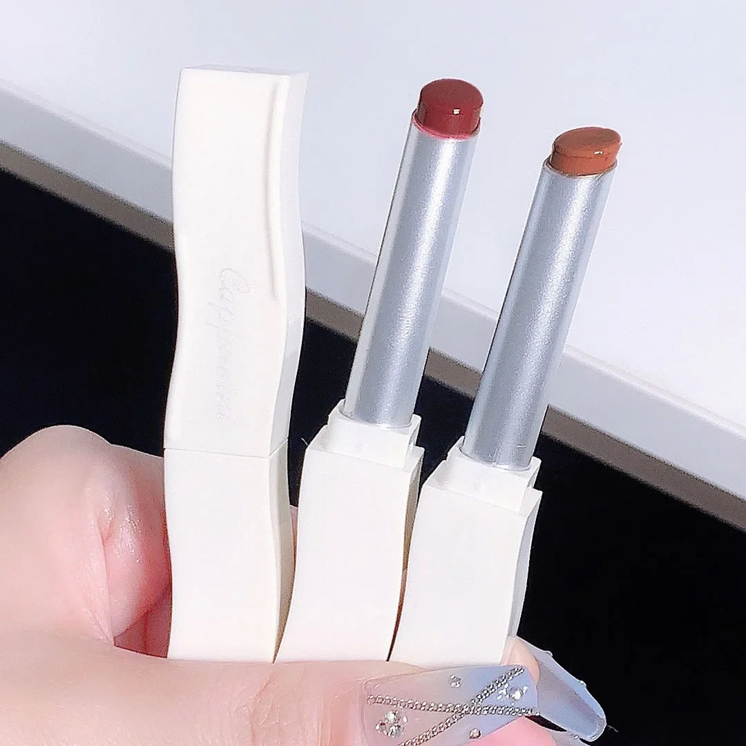 Blushimmer mirror lip gloss in a transparent tube with a pretty flower design, featuring six moisturizing nude liquid lipstick shades.