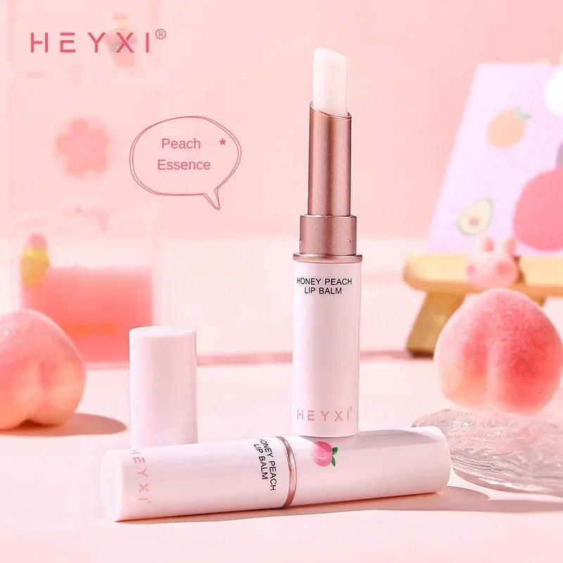 Blushimmer Honey Peach Lip Balm showing moisturizing, color-changing lipstick on lips, with a plumping and hydrating effect.