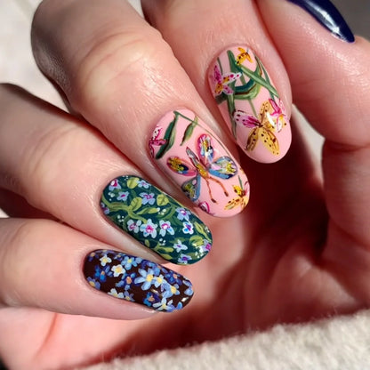 Glossy almond-shaped false nails by Blushimmer in dark green with mushroom pattern, gold sequins, and French style design.