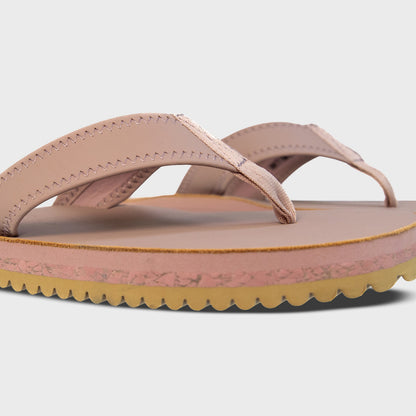 Pair of Fleks Seagrove Flip Flops in blushed color, showing side profile view with straps and sole detail.