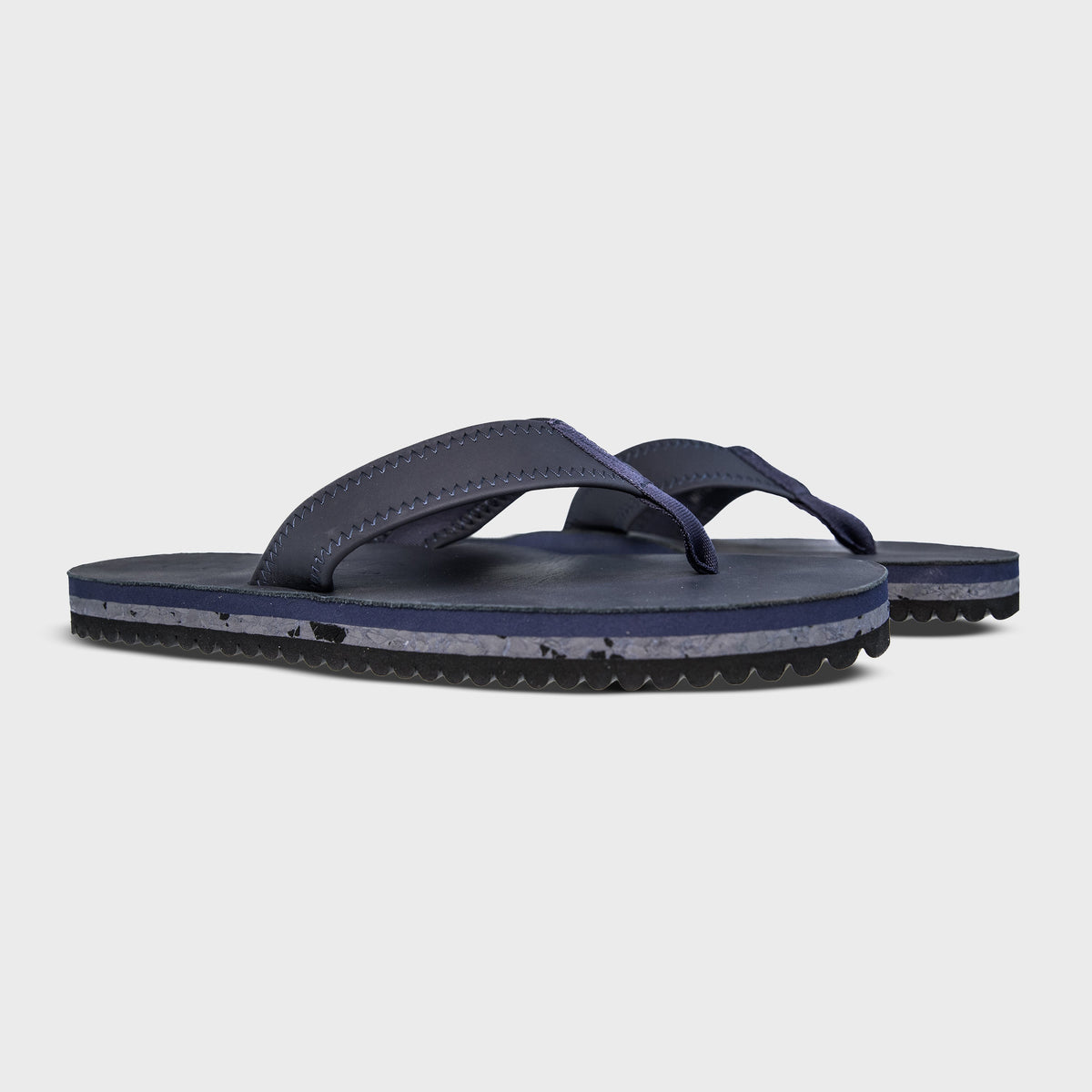 Pair of Fleks Seagrove Flip Flops in deep blue sea color, featuring a comfortable strap design and casual summer style.