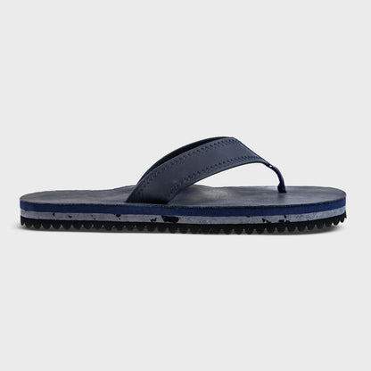 Fleks Seagrove Flip Flop in deep blue sea color, showing a single profile view of the casual beach footwear.