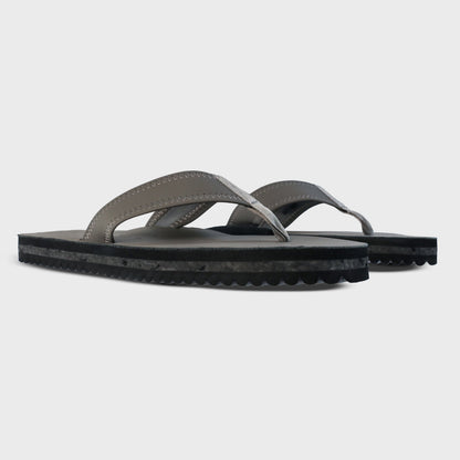 Pair of Fleks Seagrove Flip Flops in Nightfall color, showing side profile with strap details on a neutral background.