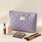 Pink Blushimmer Airfriend makeup bag with soft fabric, floral design, and zipper closure, ideal for women's travel and toiletry organization.