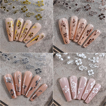White and black 3D hibiscus flower nail stickers by Blushimmer with pink and gold floral decals for nail art decoration.