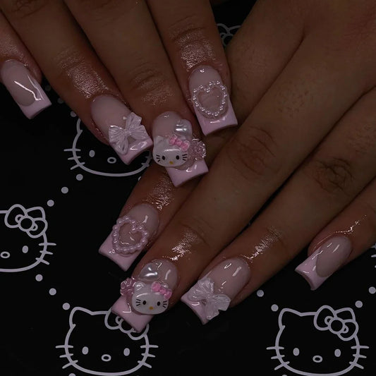 Pink French nail set with cute cartoon cat and white love camellia designs from Blushimmer, featuring jelly powder finish and bow accents.
