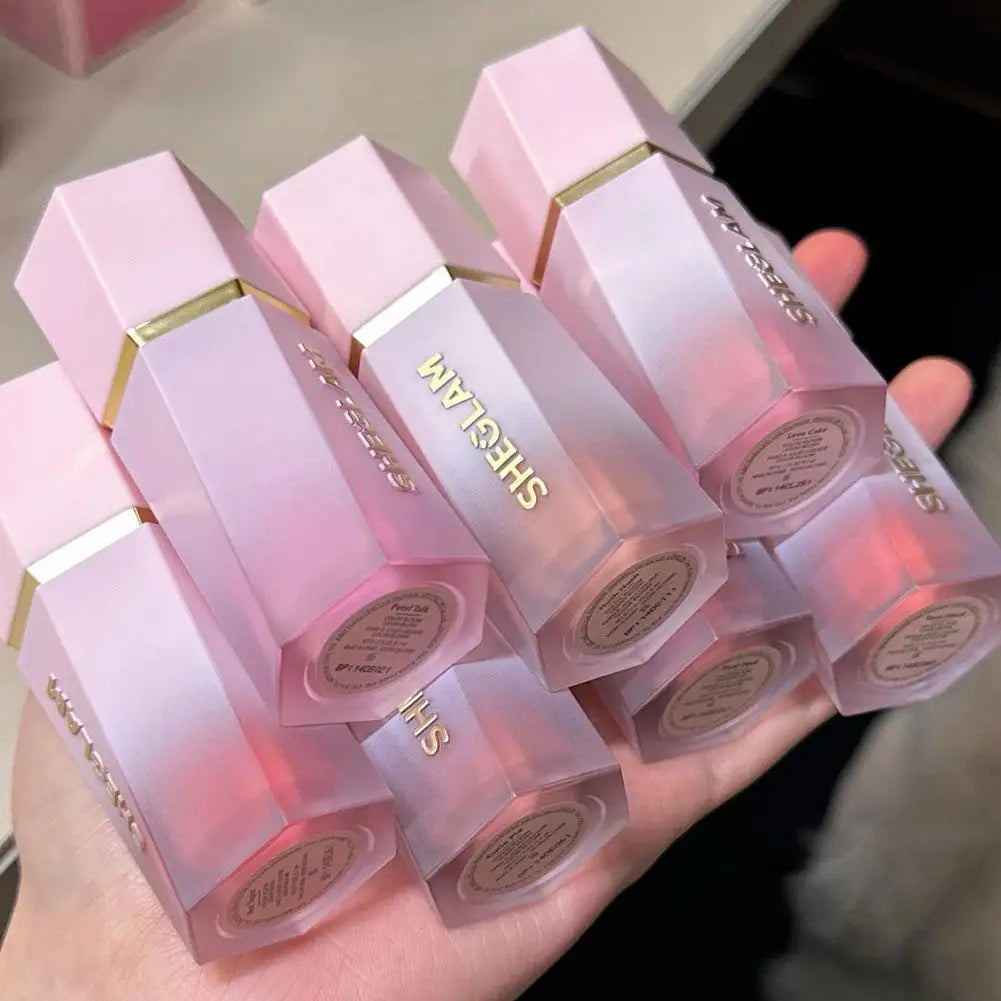 Blushimmer SHEGLAM liquid blush and highlighter gel with nourishing formula, featuring multi-purpose makeup and lip gloss in sleek packaging.