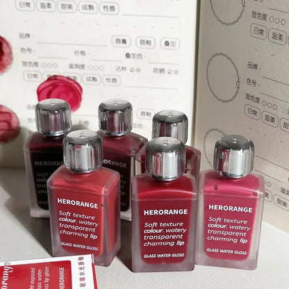 Blushimmer HERORANGE HR567 transparent ice velvet lip glaze and matte lipstick in a sleek, glossy tube, showcasing a vibrant lip color.