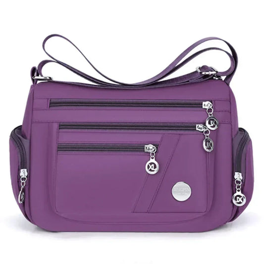 Purple LPO Ladies Crossbody Handbag with adjustable strap, stylish travel bag for women, featuring a sleek design and compact size.