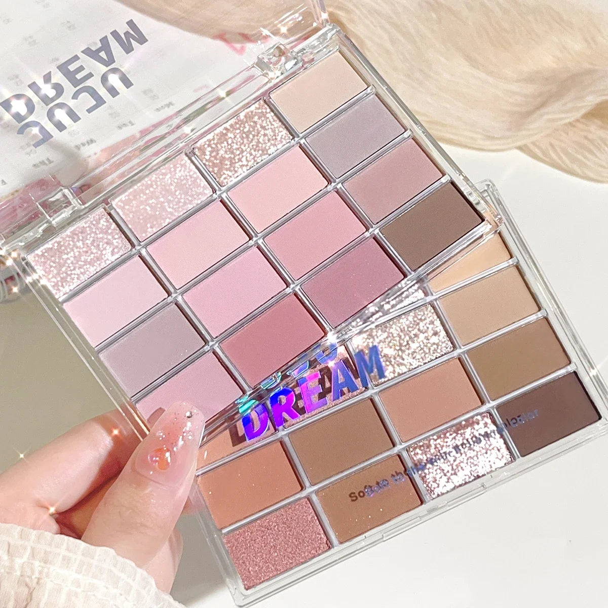 Blushimmer 16-color eyeshadow palette with pearlescent and matte shades, featuring earthy tones for daily makeup looks.