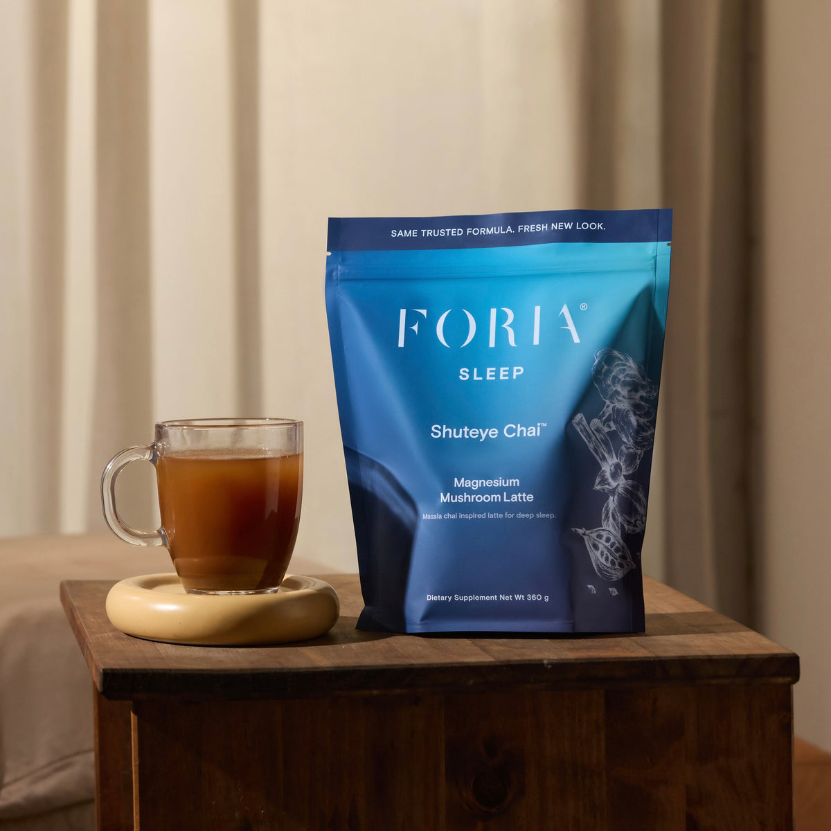 Foria Shuteye Chai Magnesium Mushroom Latte in a cozy setting, showcasing the beverage in a mug with chai spices and mushrooms.
