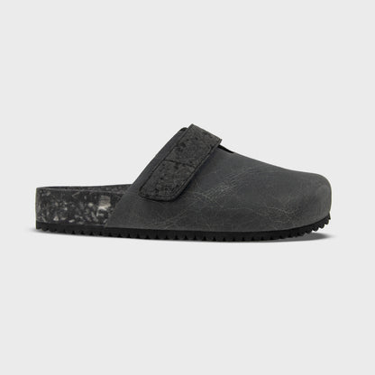 Fleks More Mesa Clog in After Dark color, side profile showing black slip-on clog with textured sole and rounded toe.