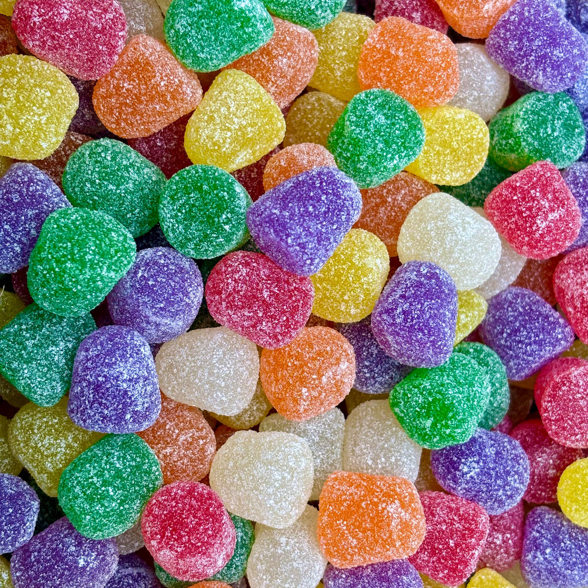 Assorted Spice Drops gummy candies in a bulk value bag from Candy In Bulk, colorful spicy-flavored gummy candies on a white background.
