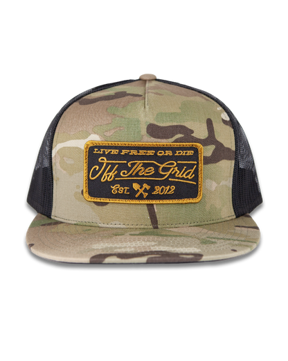 Multicam stamped snapback hat by Off The Grid Surplus, featuring a bold stamped design and adjustable brim.
