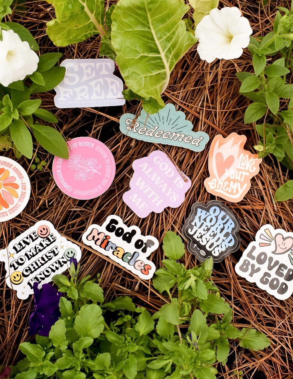 Assorted colorful stickers from Elevated Faith, featuring various designs and inspirational themes, arranged in a random pattern.
