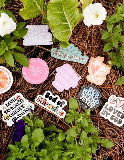 Assorted colorful stickers from Elevated Faith, featuring various designs and inspirational themes, arranged in a random pattern.
