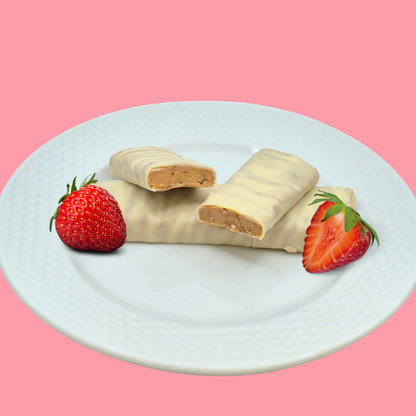 AmBari Nutrition strawberry cheesecake protein bar showing a close-up of the bar with a creamy strawberry filling and crunchy texture.