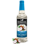 Bottle of Syruvia sugar-free coconut syrup with a clear label, showing the syrup inside and a tropical-themed background.