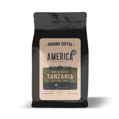 Ground Tanzania single origin coffee from America Supply Company LLC, showing fresh coffee grounds in a clear container.