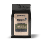 Ground Tanzania single origin coffee from America Supply Company LLC, showing fresh coffee grounds in a clear container.