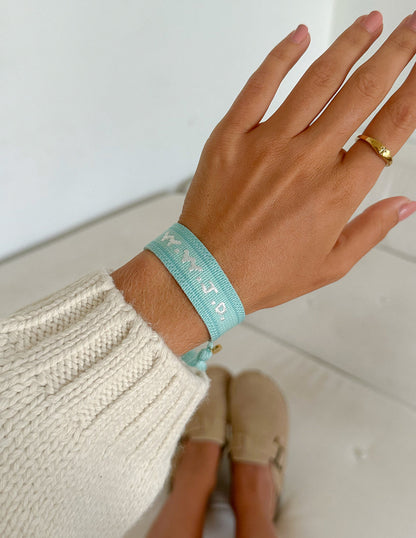 Teal WWJD embroidered wristband bracelet by Elevated Faith featuring religious message and detailed stitching.