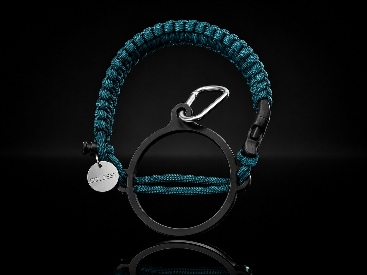 Coldest Paracord Handle accessory in teal and black with intricate braided design on a neutral background.