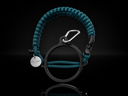 Coldest Paracord Handle accessory in teal and black with intricate braided design on a neutral background.