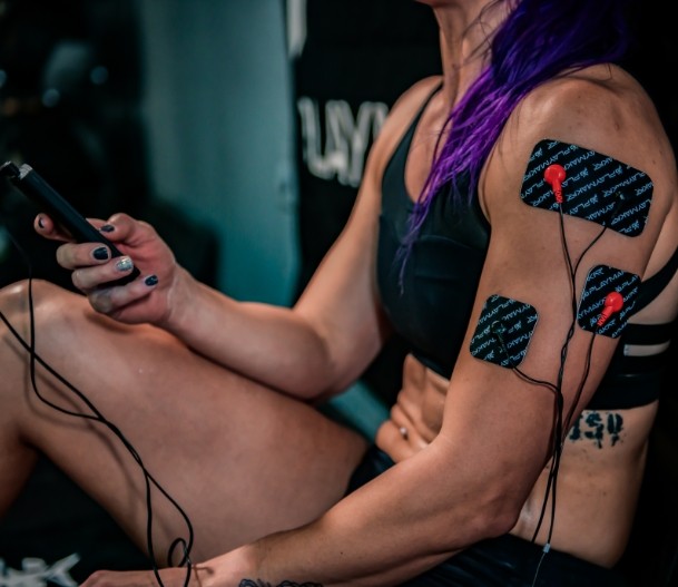 iReliev SPORT TENS + EMS Muscle Stimulator device for targeted muscle pain relief and muscle stimulation therapy.