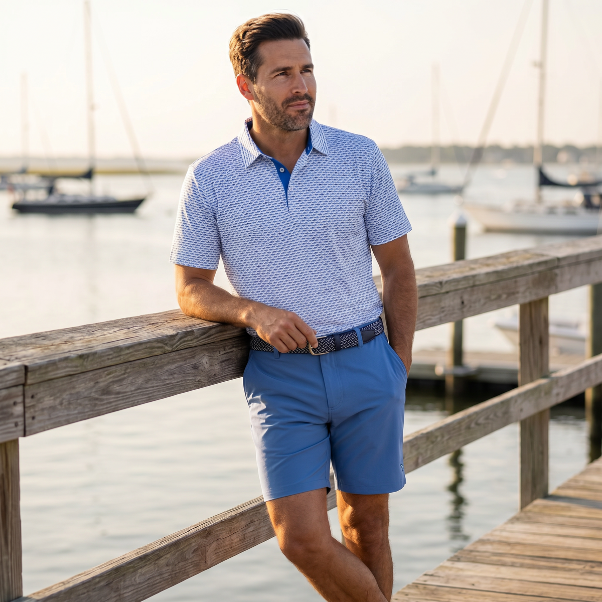 Light blue and navy Tuna Performance Polo by White Water Life, featuring a classic polo shirt design with a collar and short sleeves.