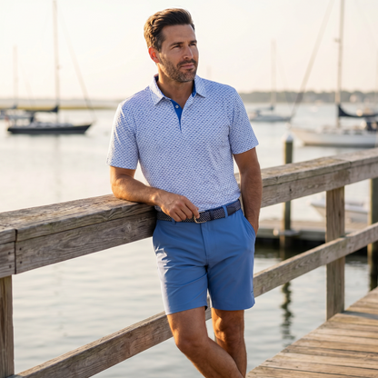 Light blue and navy Tuna Performance Polo by White Water Life, featuring a classic polo shirt design with a collar and short sleeves.