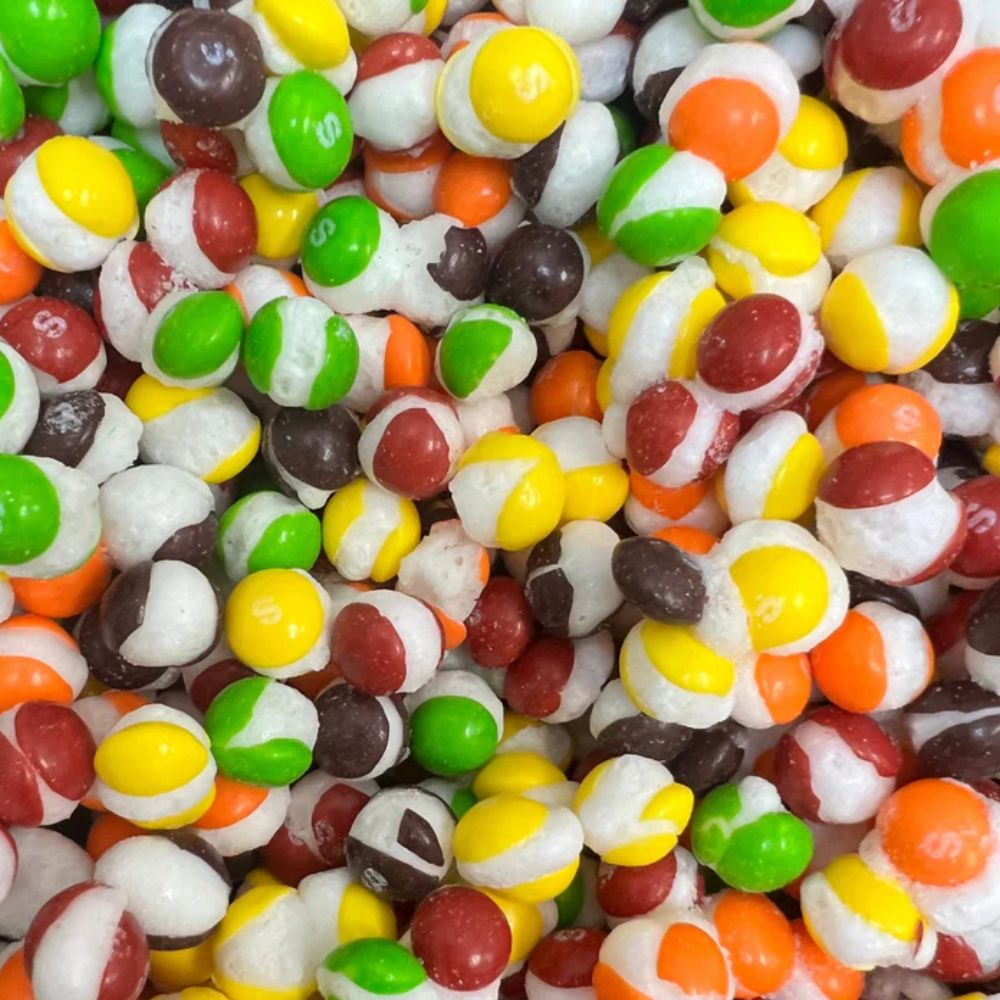 Frozen Skittles POP'd original candy from Candy In Bulk in a large bulk bag, showing colorful freeze-dried Skittles pieces.