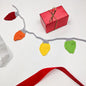 Crochet pattern for Christmas light bulb garland by Darn Good Yarn, featuring colorful crochet holiday string lights for beginner crafters.