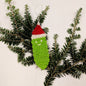Crochet Christmas pickle ornament with colorful yarn, handmade holiday decoration, created by Darn Good Yarn for festive decor.