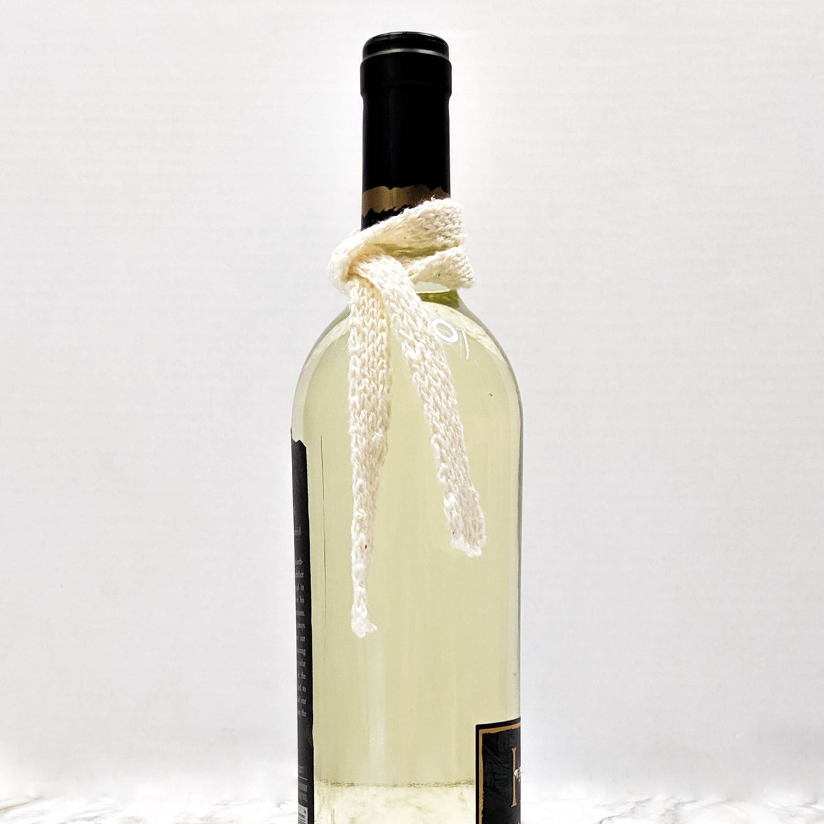 Winter bottle scarf knitting pattern by Darn Good Yarn, featuring a cozy mini scarf for holiday bottles and ornaments.