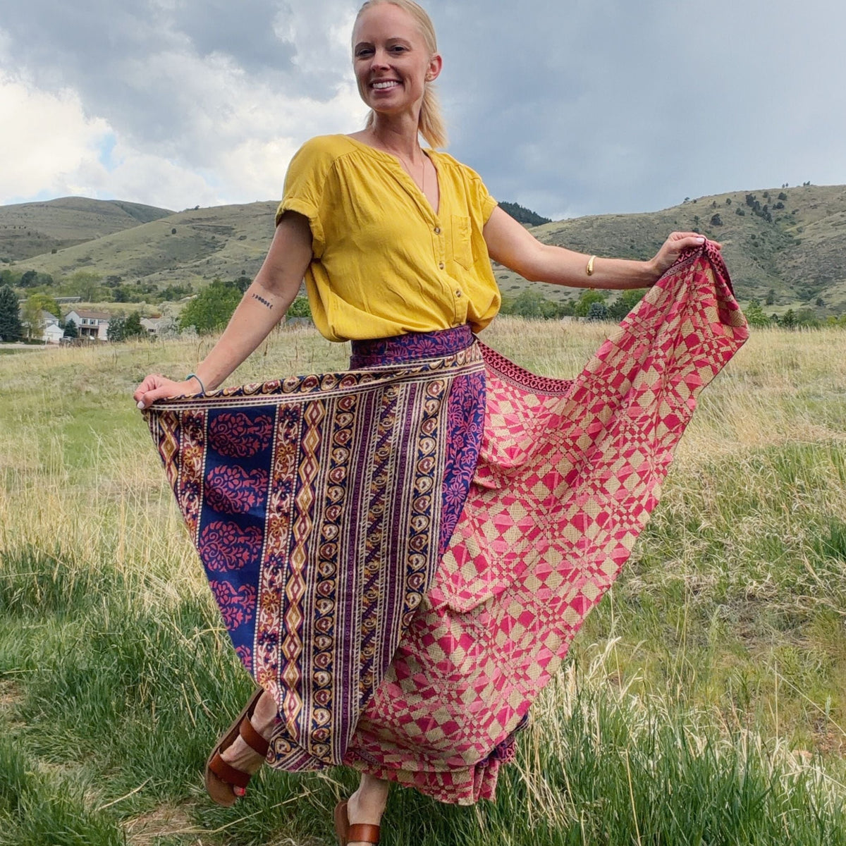 Darn Good Yarn Made With Love saree wrap skirt in vibrant fabric with intricate patterns, styled as a versatile clothing accessory.