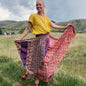 Darn Good Yarn Made With Love saree wrap skirt in vibrant fabric with intricate patterns, styled as a versatile clothing accessory.