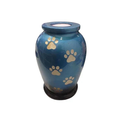 Onyxcrafts Paw Sapphire urn with a detailed paw print design in blue and silver, crafted from ceramic, set against a neutral background.