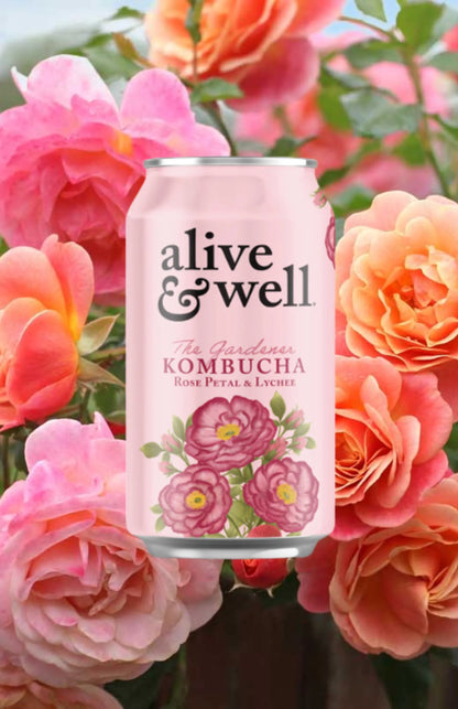 Organic rose petal and lychee flavored kombucha by Alive & Well, shown in a six-pack of bottled kombucha drinks.