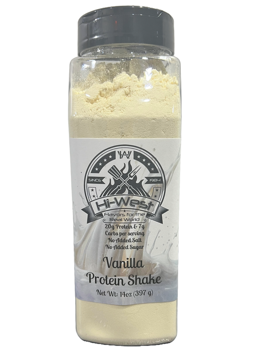 Vanilla protein shake by Hi-West Foods, Inc. in a clear glass with a creamy vanilla color and a straw, ready to drink.