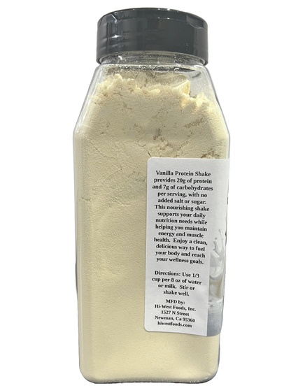 Creamy vanilla protein shake from Hi-West Foods, Inc. in a clear glass, topped with a swirl of whipped cream and vanilla bean seeds.