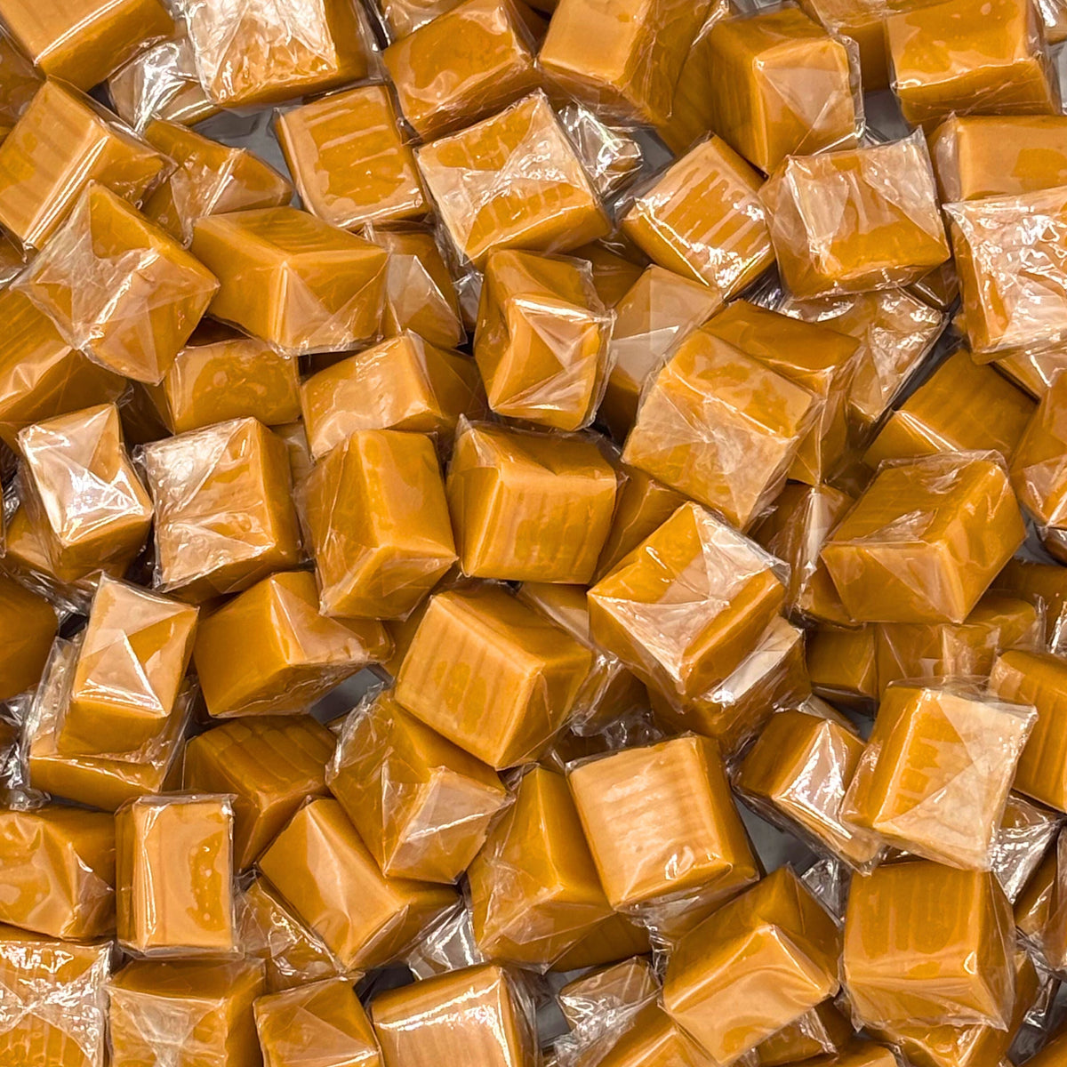 Assorted vanilla caramel squares candy from Candy In Bulk, individually wrapped and displayed in a bulk value bag.
