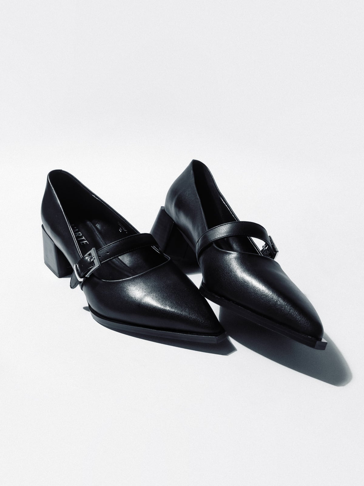 Black women's leather shoes by L'ARTE MILANO with sleek design and stylish ankle straps, perfect for elegant footwear.