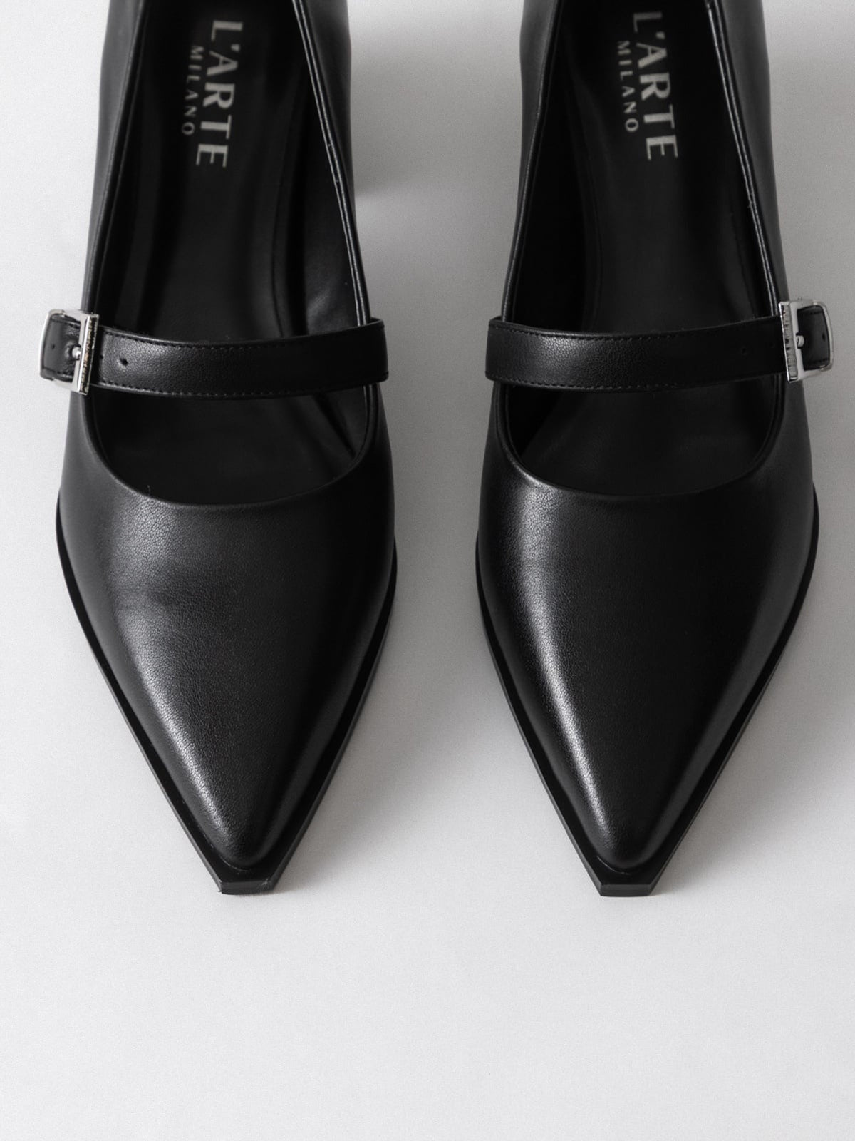 Black women's leather shoes by L'ARTE MILANO, stylish footwear with sleek design and polished finish.